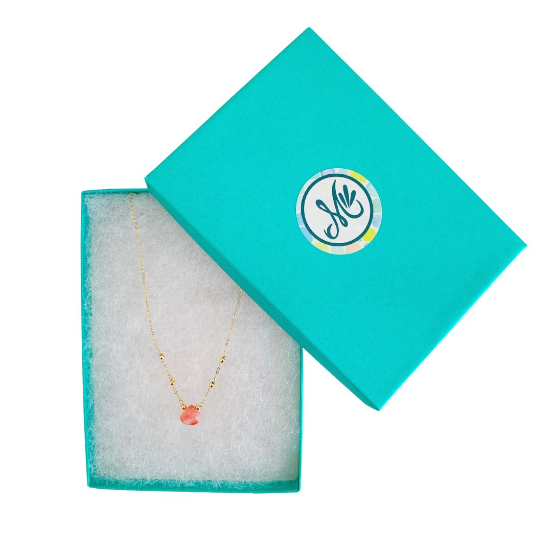 Chatham Necklace by Mermaids and Madeleines features a cherry quartz briolette drop and 14k gold filled beads, findings and chain. This one is pictured in a cotton lined teal gift box on a white surface