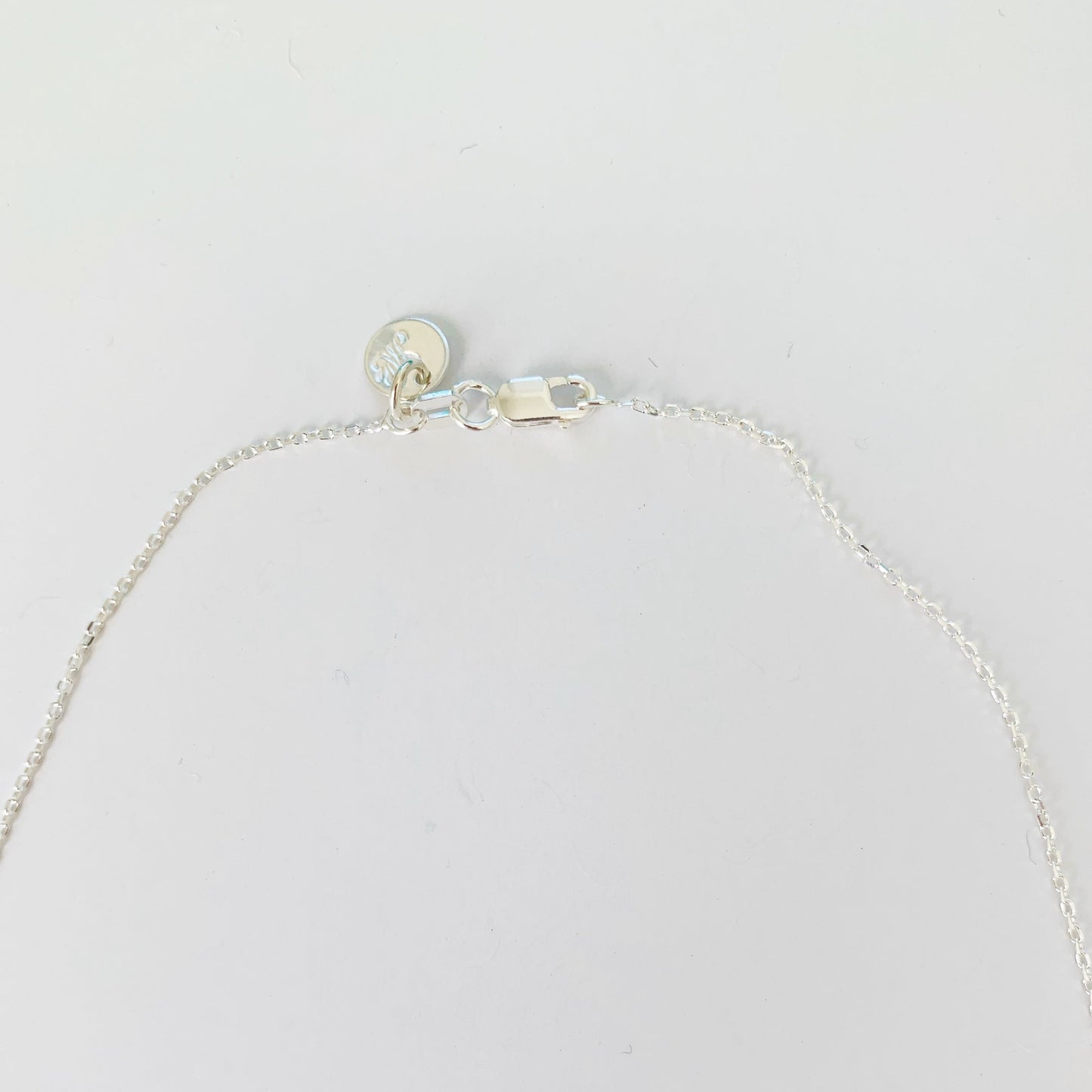 the back of the raindrop necklace is clasped with a lobster claw shown here