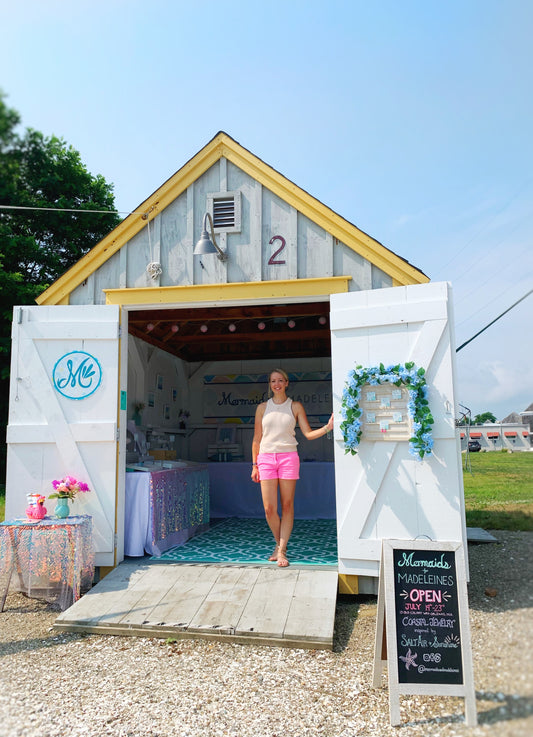 Heather of Mermaids and Madeleines standing in the doorway of her temporary artist cottage in Orleans on Cape Cod