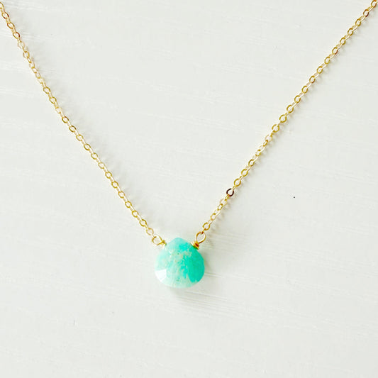Gold necklace with a teal amazonite bead on a white background