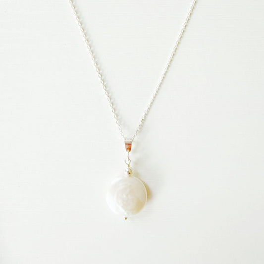 Necklace with a large pearl pendant on a white background