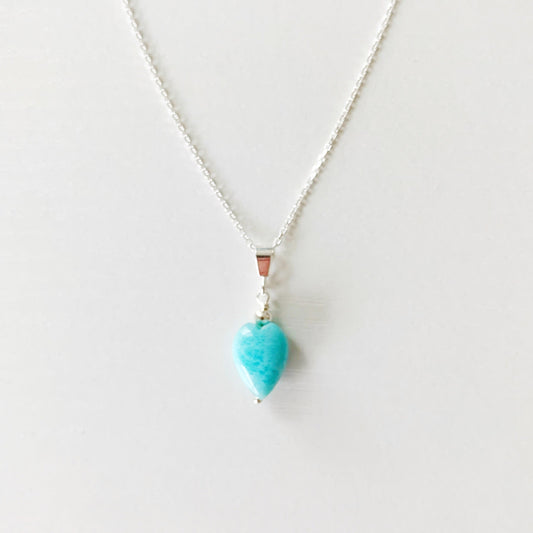 the ocean lover pendant necklace by mermaids and madeleines is created with sterling silver chain and a heart shaped larimar drop. this necklace is photographed on a white background