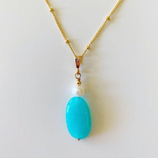 the summer storm pendant necklace by mermaids and madeleines is a one of a kind piece. this necklace is a pendant style with an oblong amazonite bead and freshwater pearl drop with 14k gold filled bead chain. this necklace is photographed on a white surface