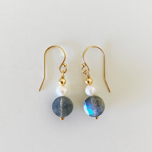 the arctic earrings by mermaids and madeleines are a simple dangle style earring with a small freshwater pearl, and faceted coin labradorite gem. this pair has 14k gold filled findings and is photographed on a white background