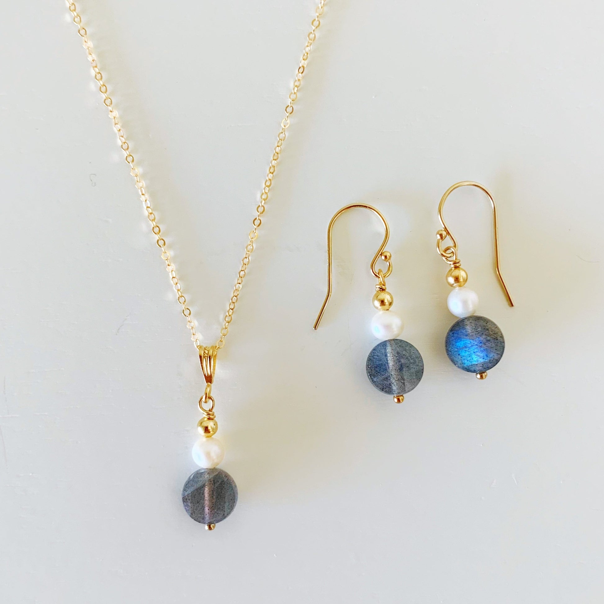 the arctic pendant and earrings by mermaids and madeleines are designed with small freshwater pearls, faceted labradorite coins and 14k gold filled findings and chain