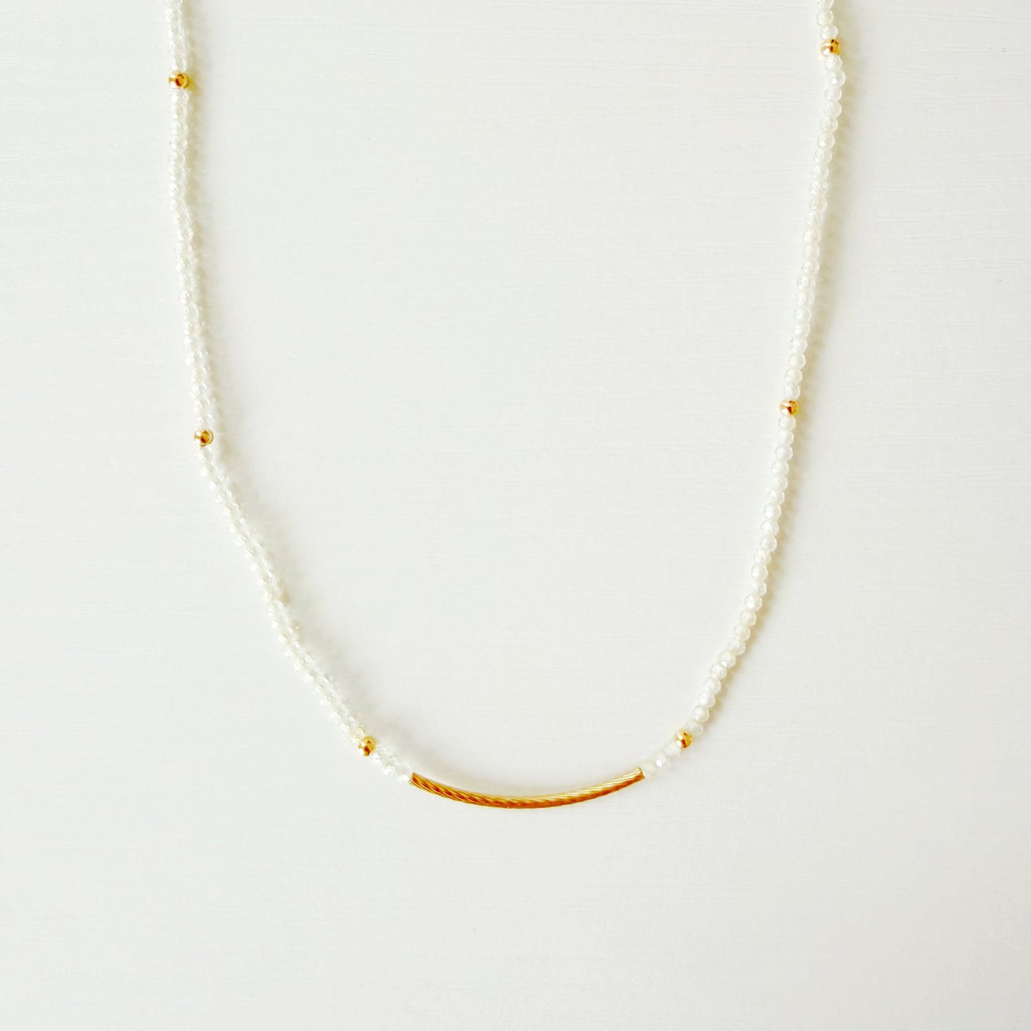 Delicate necklace with small beads on a white background