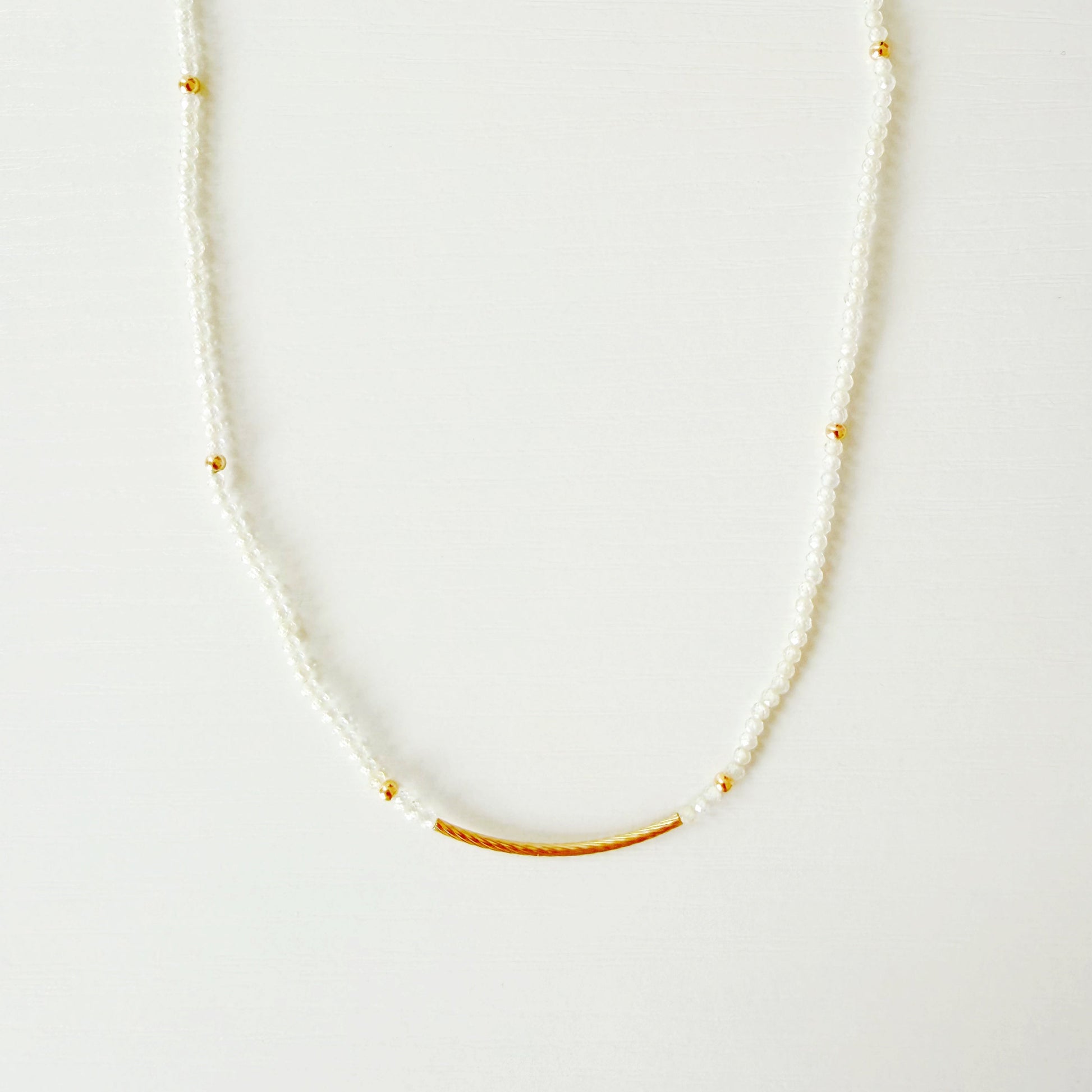 Delicate necklace with small beads on a white background