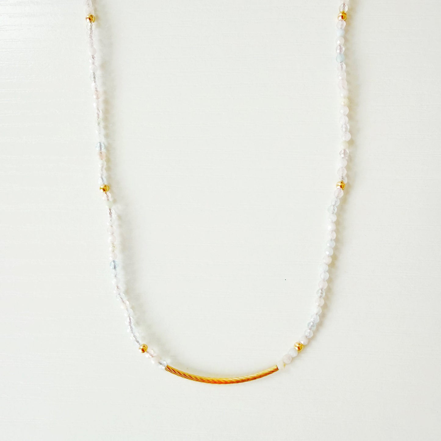 Necklace with small pastel beads on a white background