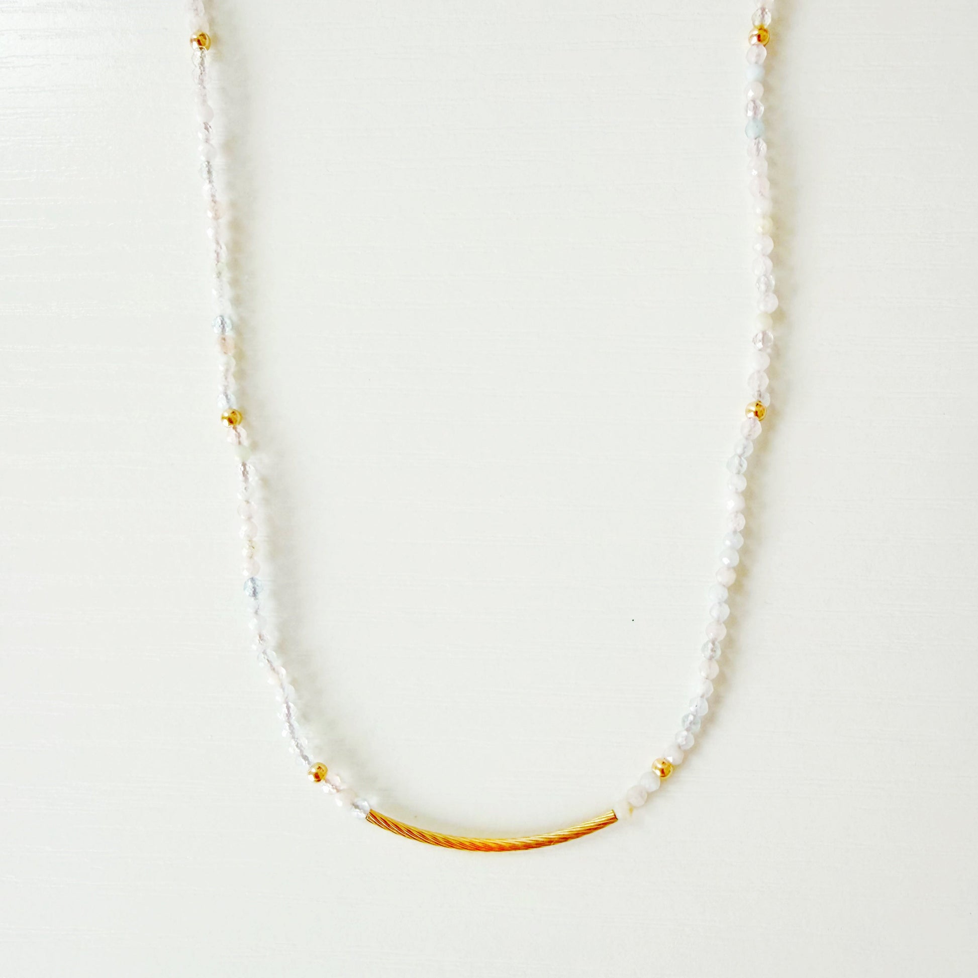 Necklace with small pastel beads on a white background