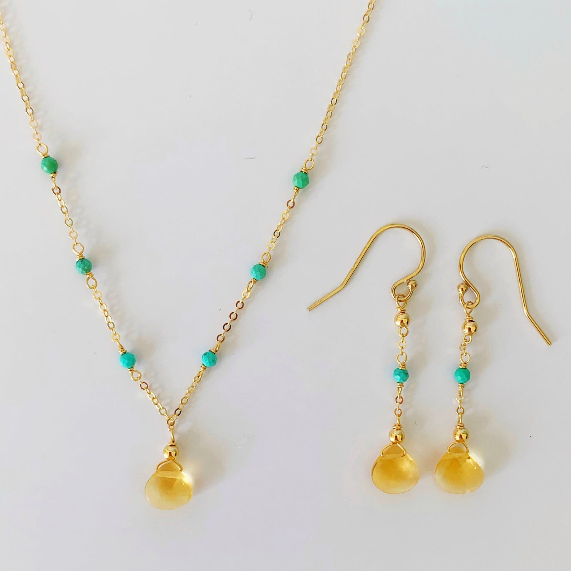an image of the ray of sunshine earrings and necklace together over a white background