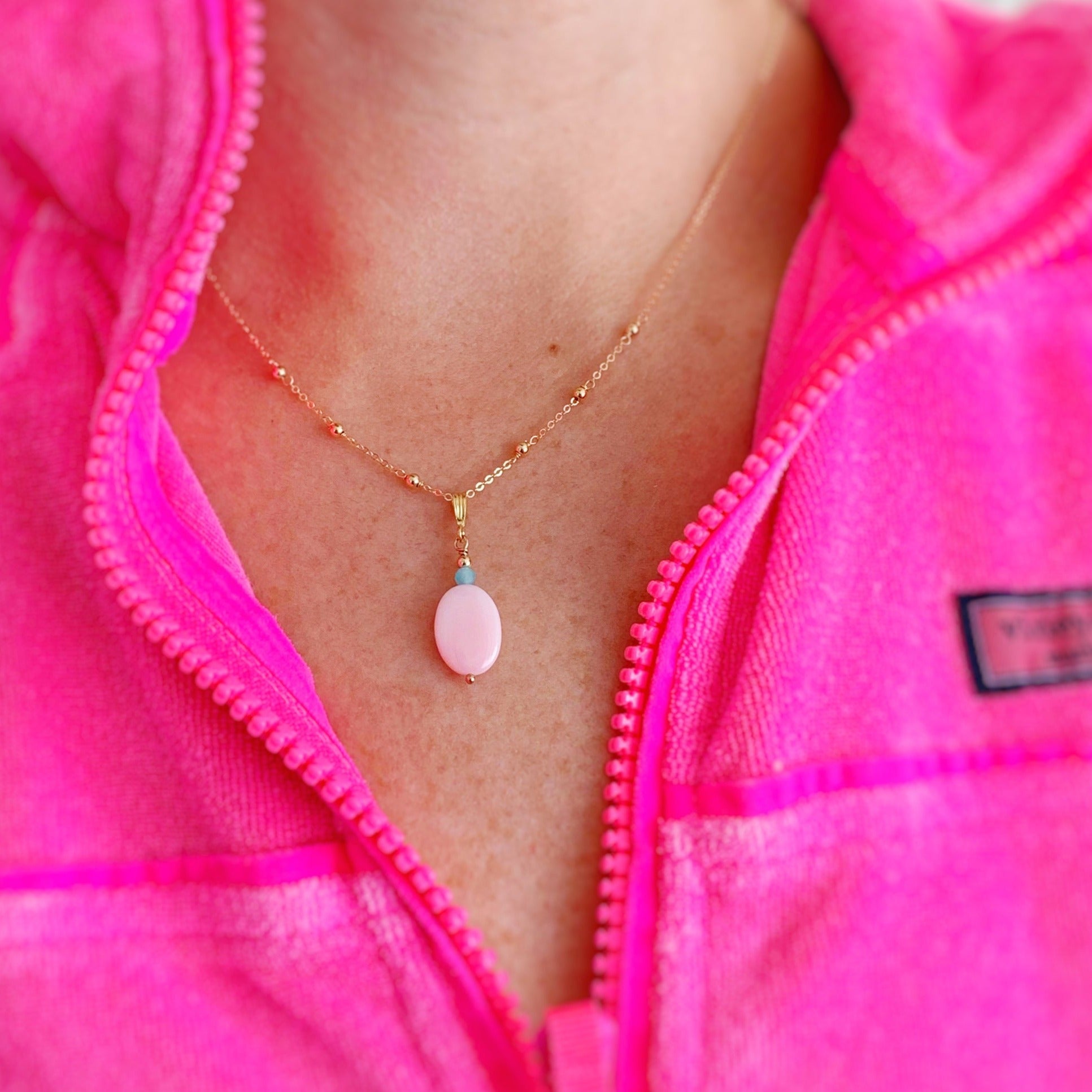 the sanibel necklace pictured on a person