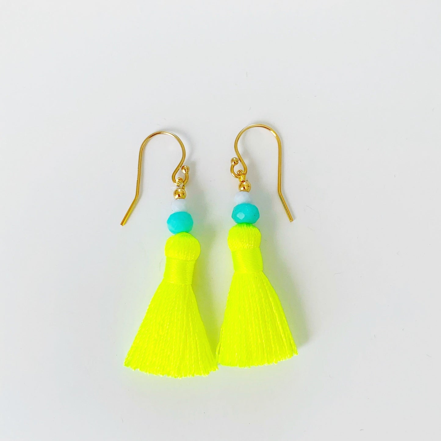 Neon yellow tassel earrings with teal amazonite beads on a white background