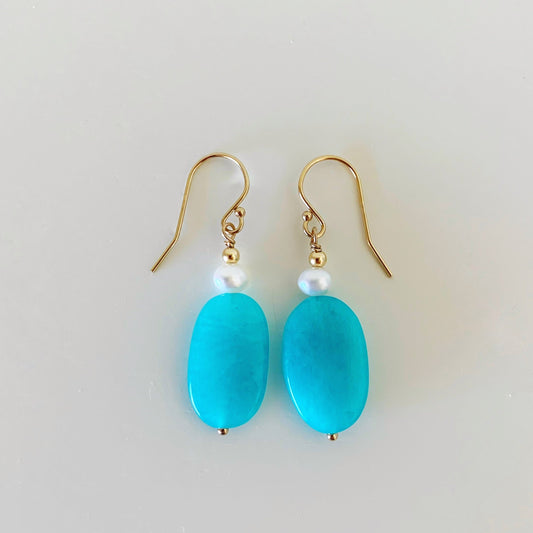 Tidal Wave earrings by mermaids and madeleines are designed with amazonite oval stones with freshwater pearls and 14k gold filled findings. this pair is photographed on a white surface
