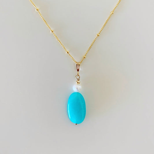 tidal wave necklace by mermaids and madeleines is created with amazonite oval with freshwater pearl and 14k gold filled chain and findings. this necklace is photographed on a white surface