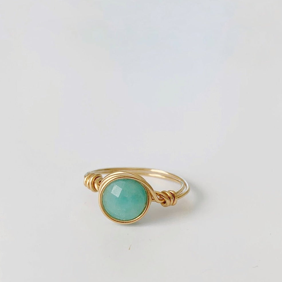 Captiva Ring by Mermaids and Madeleines is an Amazonite gem wire wrapped with 14k gold filled wire. This ring is pictured on a white background