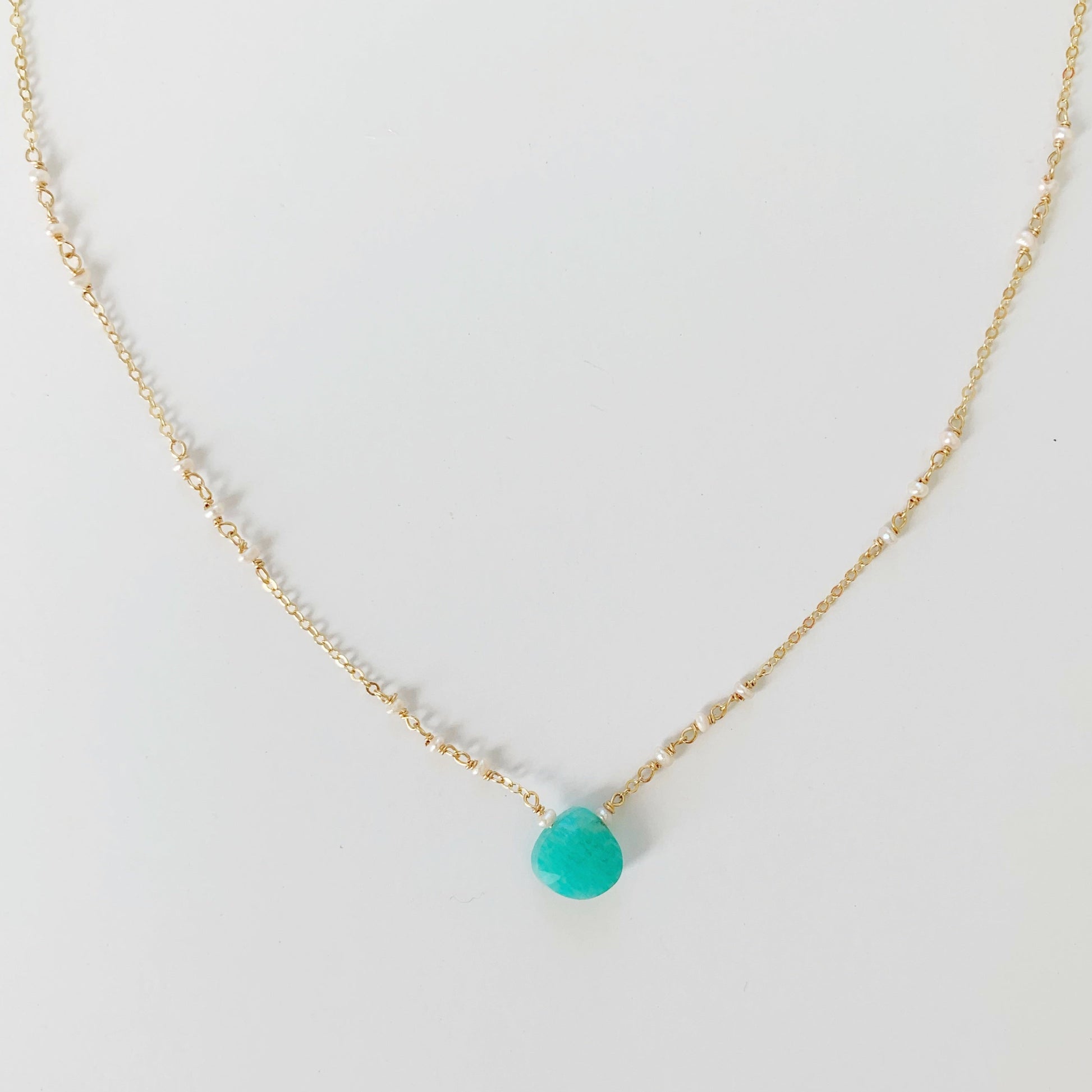 Island Air necklace by mermaids and madeleines is created with a bright amazonite game at the center and tiny freshwater pearls on 14k gold filled chain. This necklace is photographed on a white background