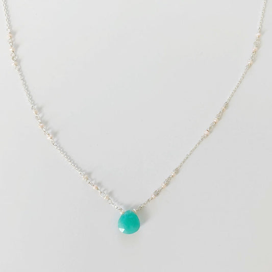 Island Air Necklace in sterling silver by mermaids and madeleines is created in with an amazonite gem at the center and tiny freshwater pearls in the chain. This necklace is pictured over a white background