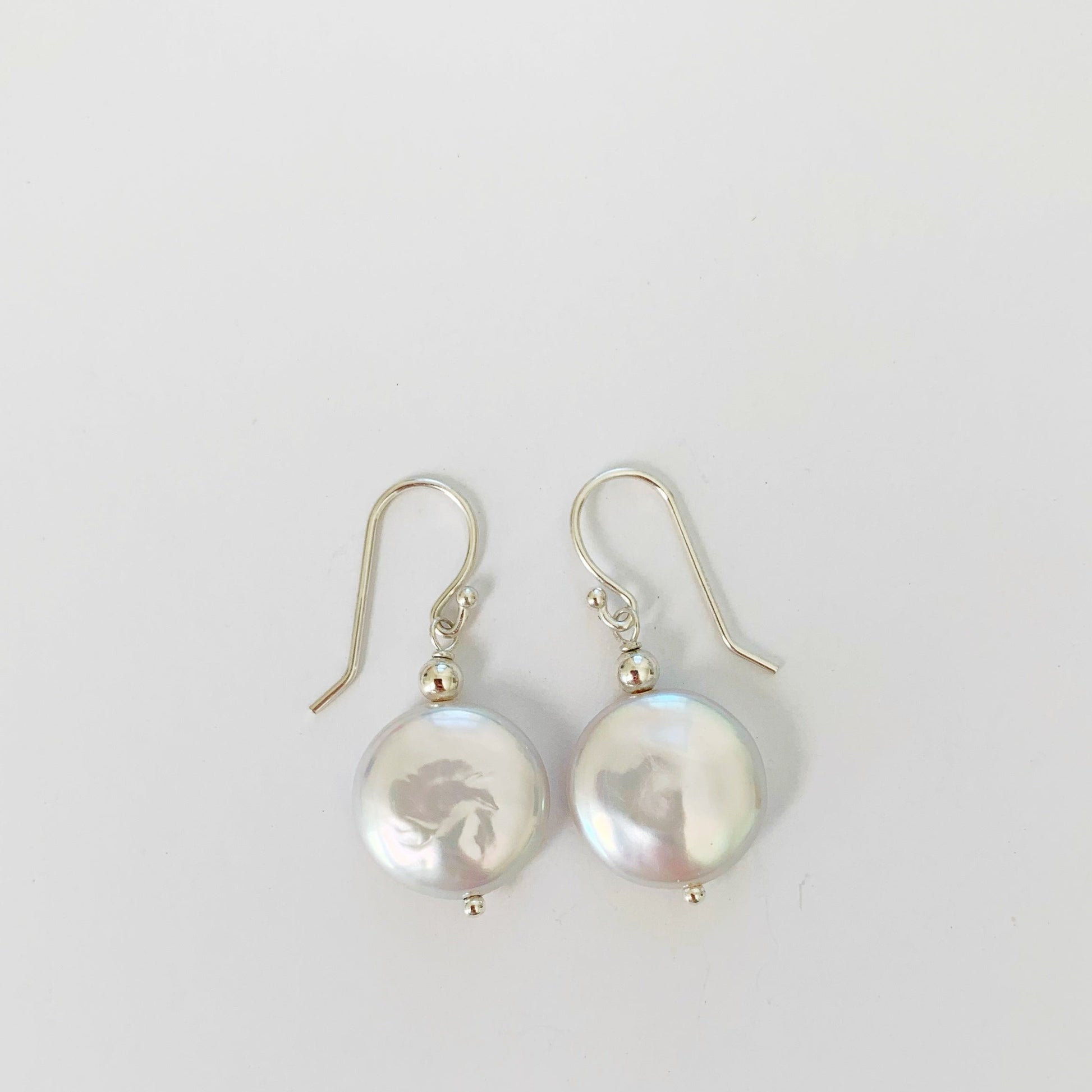 Newport Gala Sterling Silver Earrings with large freshwater coin pearl and sterling silver findings pictured on a white background