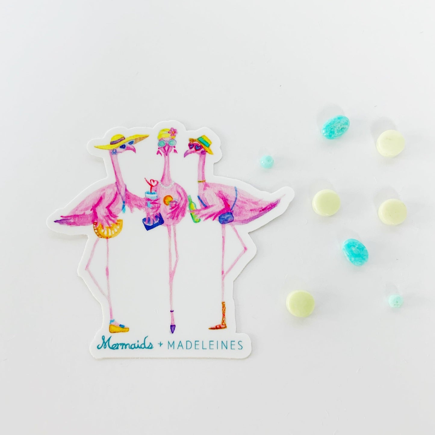 The flamingal sticker is created from original artwork made with acrylic paint and marker its 3 flamingo ladies dressed in summer hats and various footwear. This is a picture of one sticker on a white background