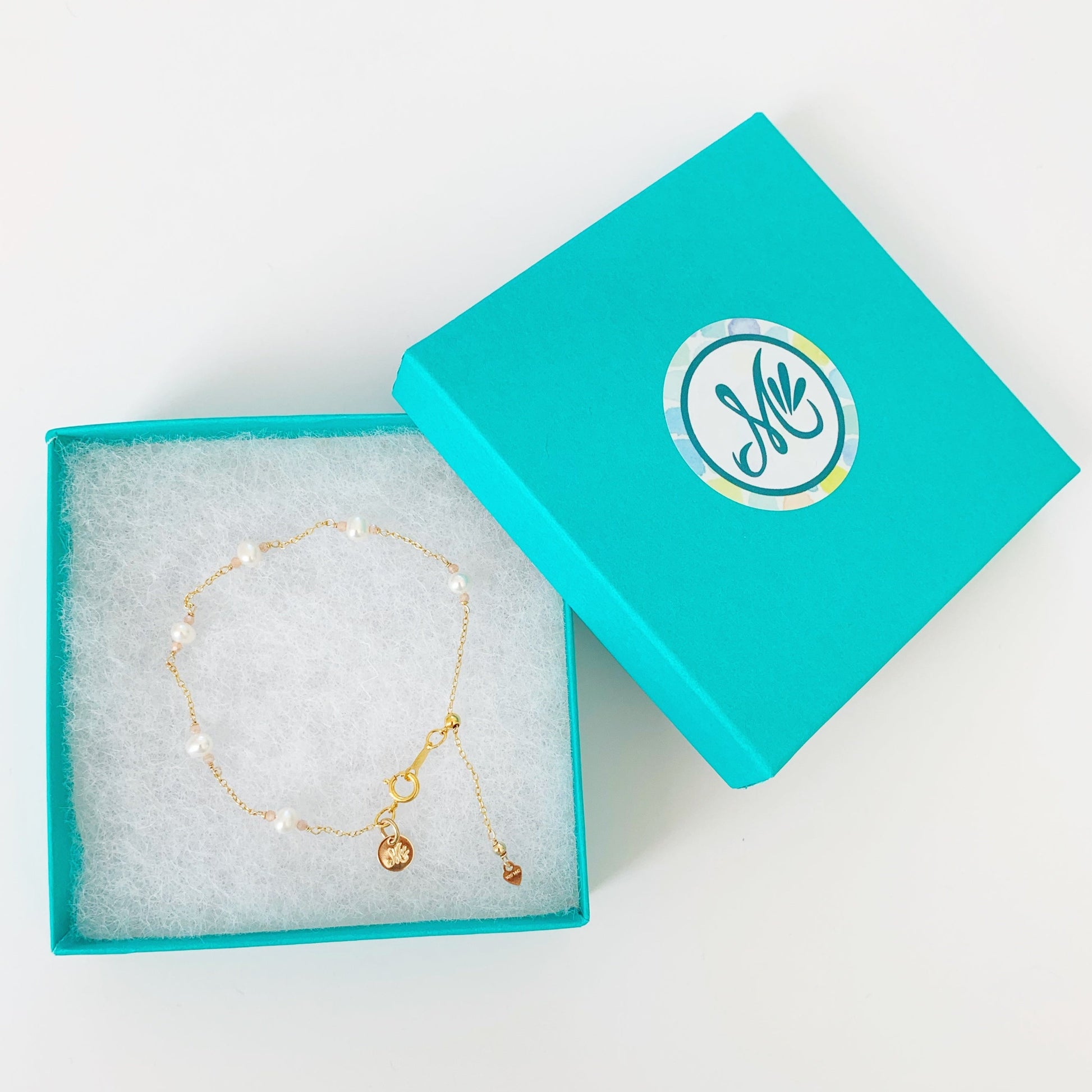 Barrington bracelet pictured in a teal gift box on a white surface