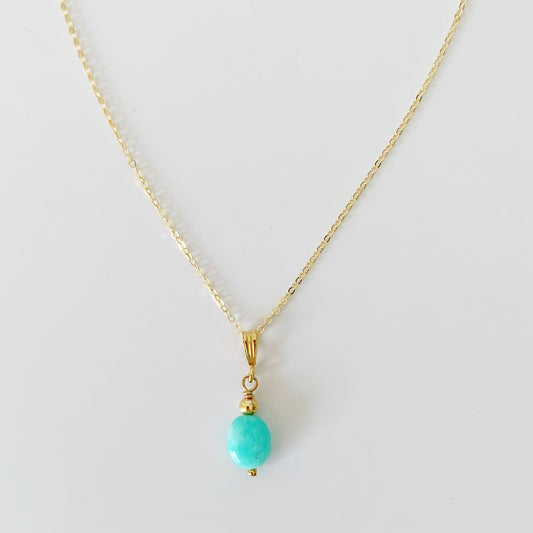 The laguna pendant by mermaids and madeleines is an oval amazonite drop on 14k gold filled chain. this necklace is photographed on a white surface