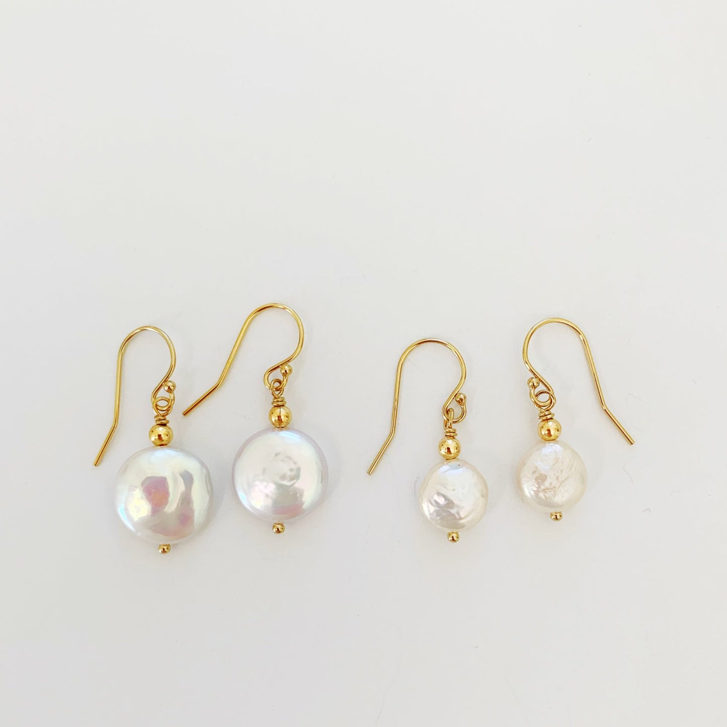 The newport gala earrings next to the newport earrings for a size comparison. both pair pictured next to each other on a white background