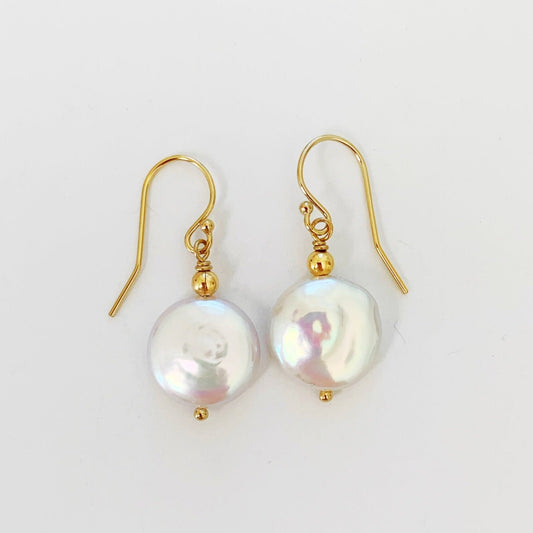 Newport Gala earrings by mermaids and madeleines have large freshwater coin pearls with 14k gold filled beads and findings. this pair is photographed on a white surface