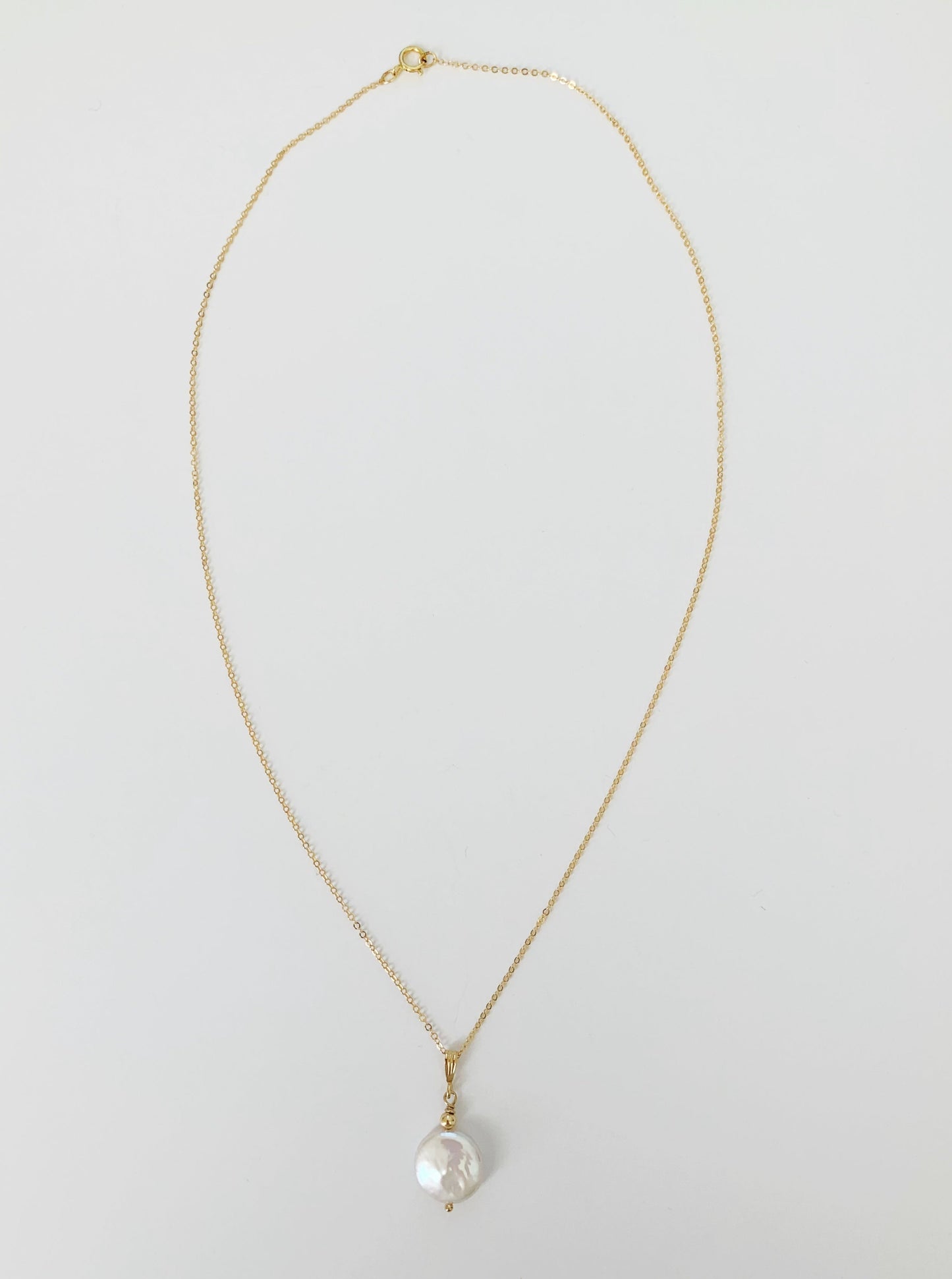 A full length view of the newport gala necklace on a white surface