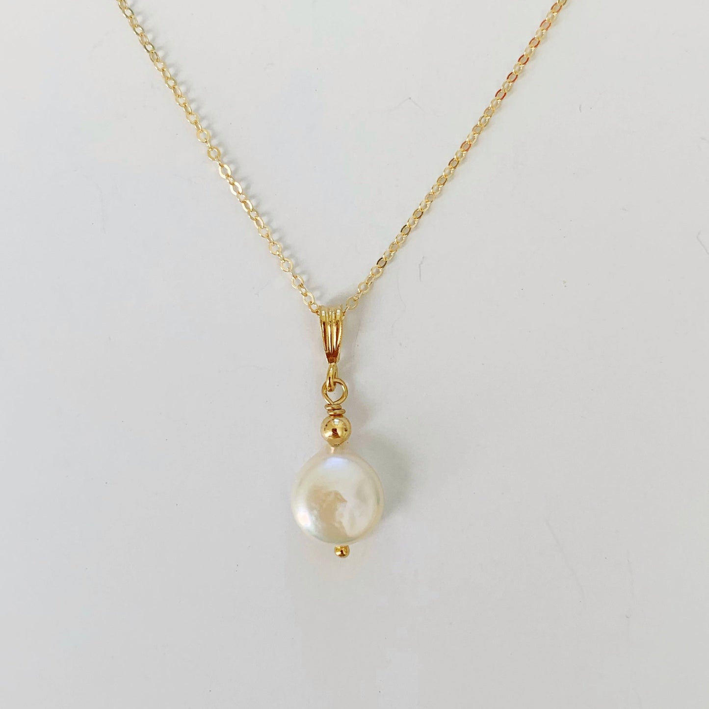 Newport Pearl Necklace is a freshwater coin pearl pendant with 14k gold filled findings and chain. this one is photographed on a white background