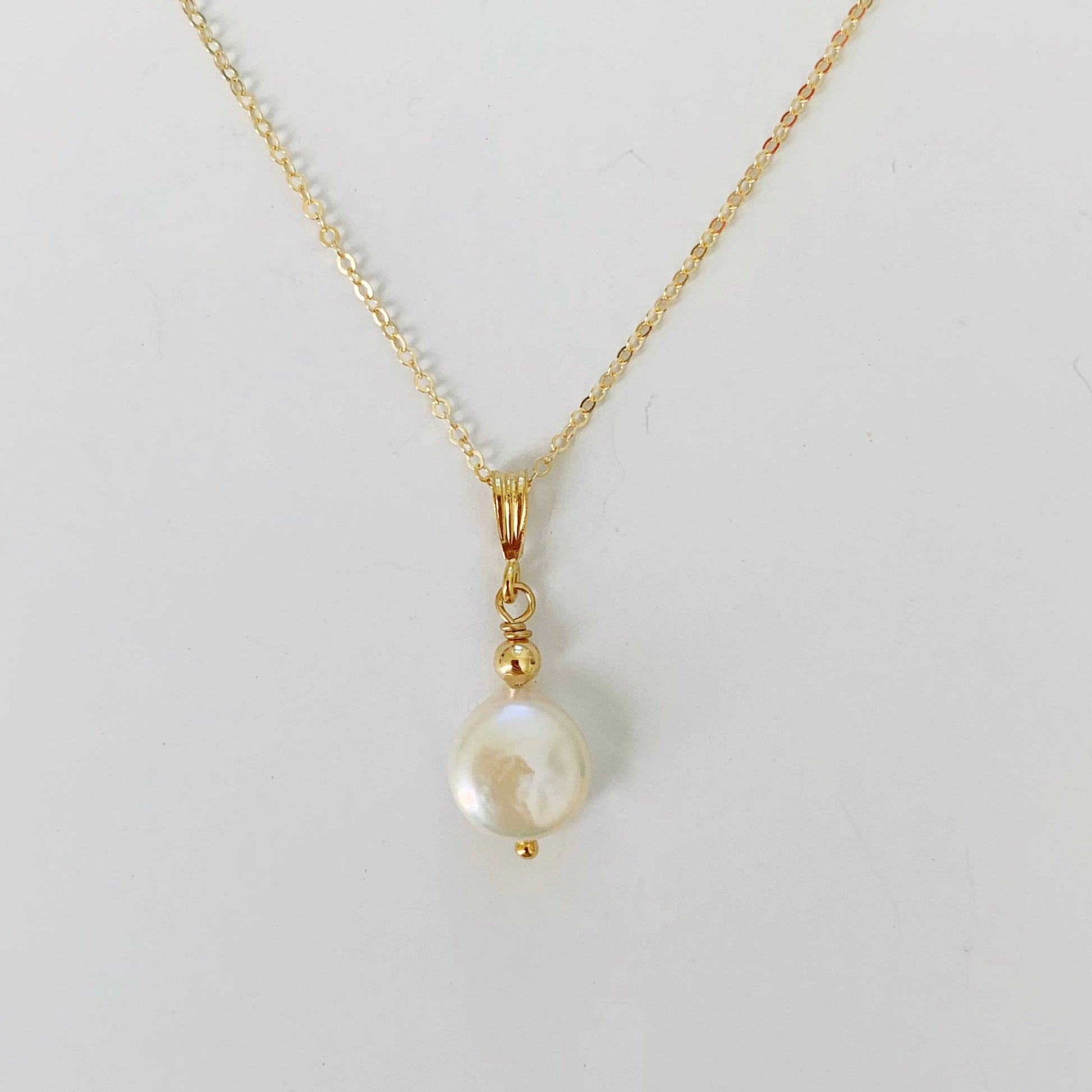 Newport Pearl Necklace is a freshwater coin pearl pendant with 14k gold filled findings and chain. this one is photographed on a white background