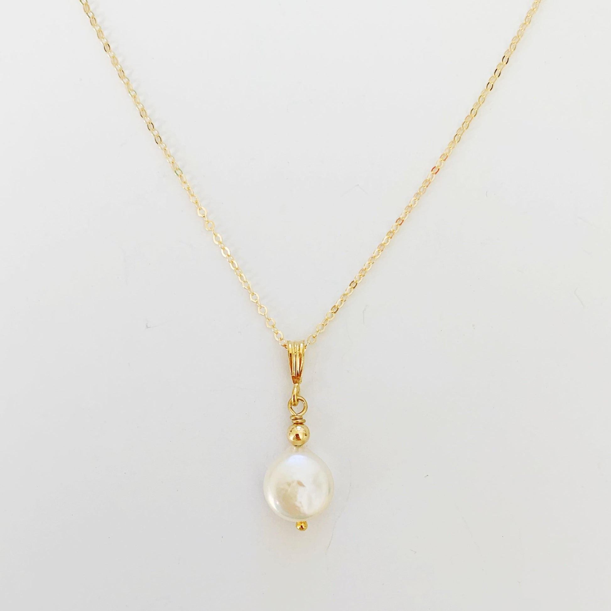 Newport Pendant featuring small freshwater coin pearl and 14k gold filled chain and findings by mermaids and madeleines. this necklace is photographed close up on a white background