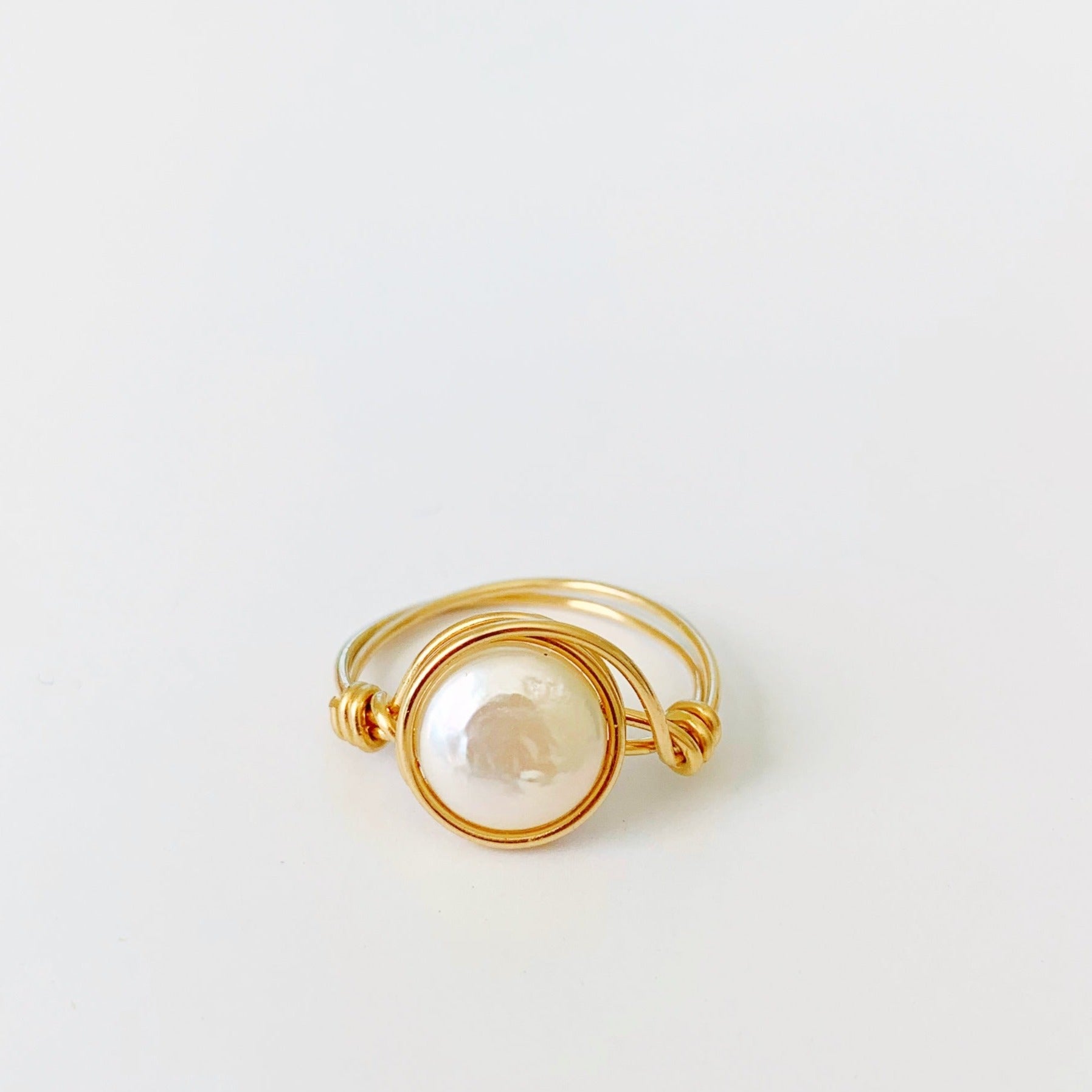 Newport Pearl wire wrapped ring by mermaids and madeleines features 14k gold filled wire and freshwater coin pearl. this ring is photographed on a white backdrop