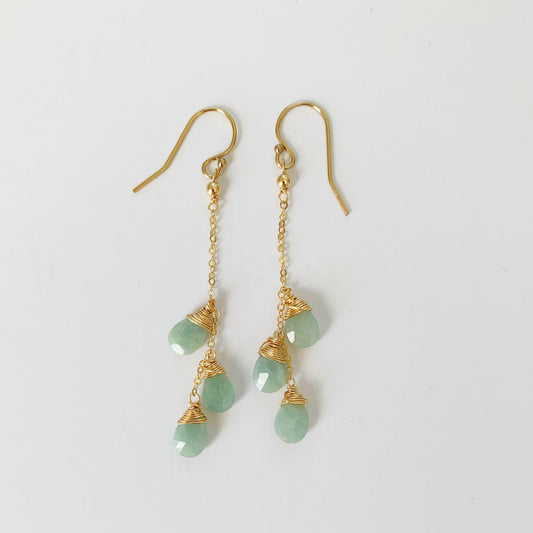 Raindrop Earrings by Mermaids and Madeleines are wire wrapped aquamarine briolettes suspended from 14k gold filled chain and findings. this pair is photographed on a white surface